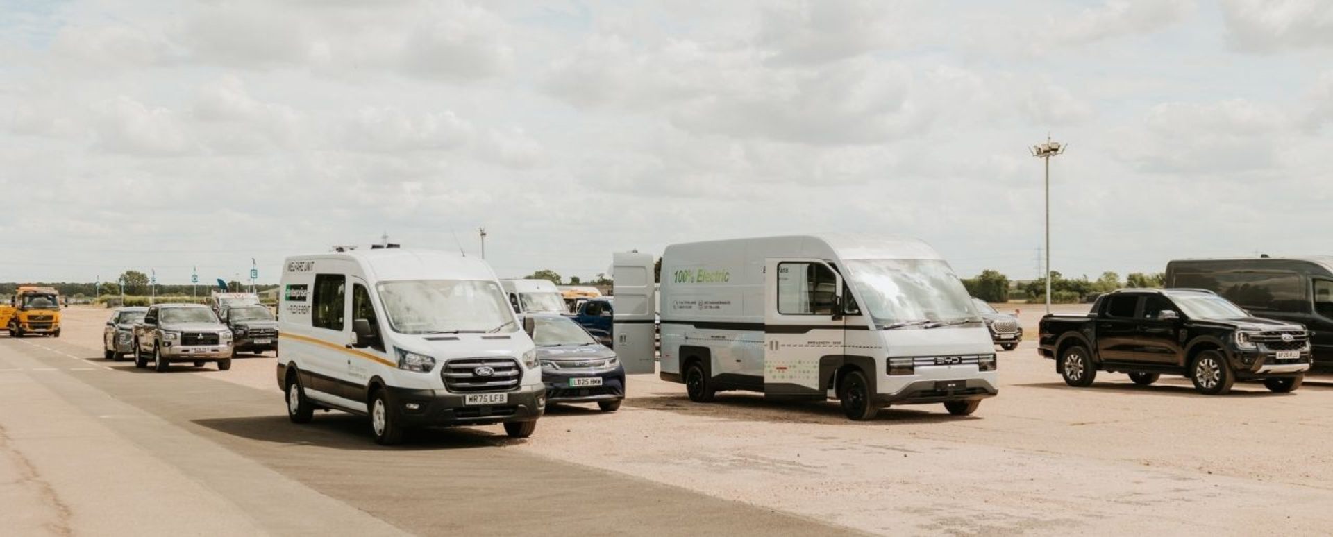 A Range Of Vans And SUVs On A Wide Road