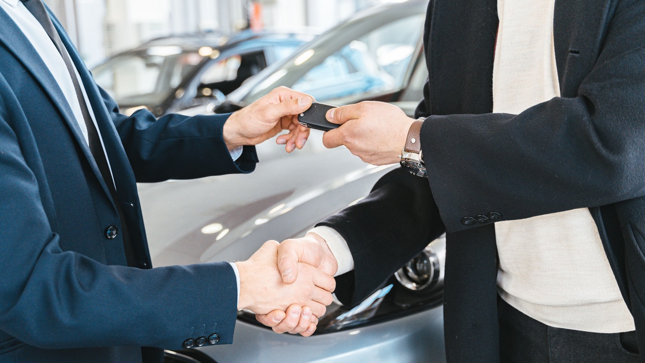 Two Men Shaking Hands Exchanging Car Keys