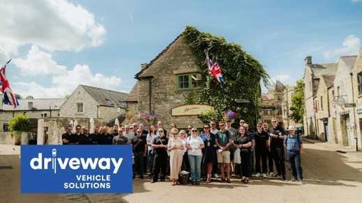 Driveway Vehicle Solutions Team Stood in Front of Old Building