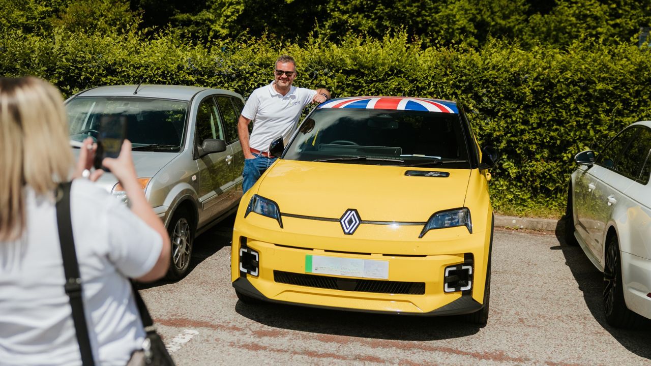 Man Leaning on Yellow Renault 5 In Car Park