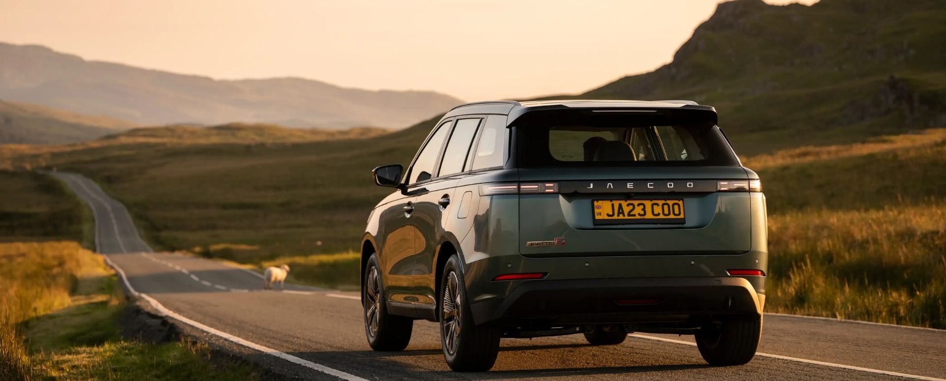 Jaecoo Vehicle Driving Down a Country Road Rear View