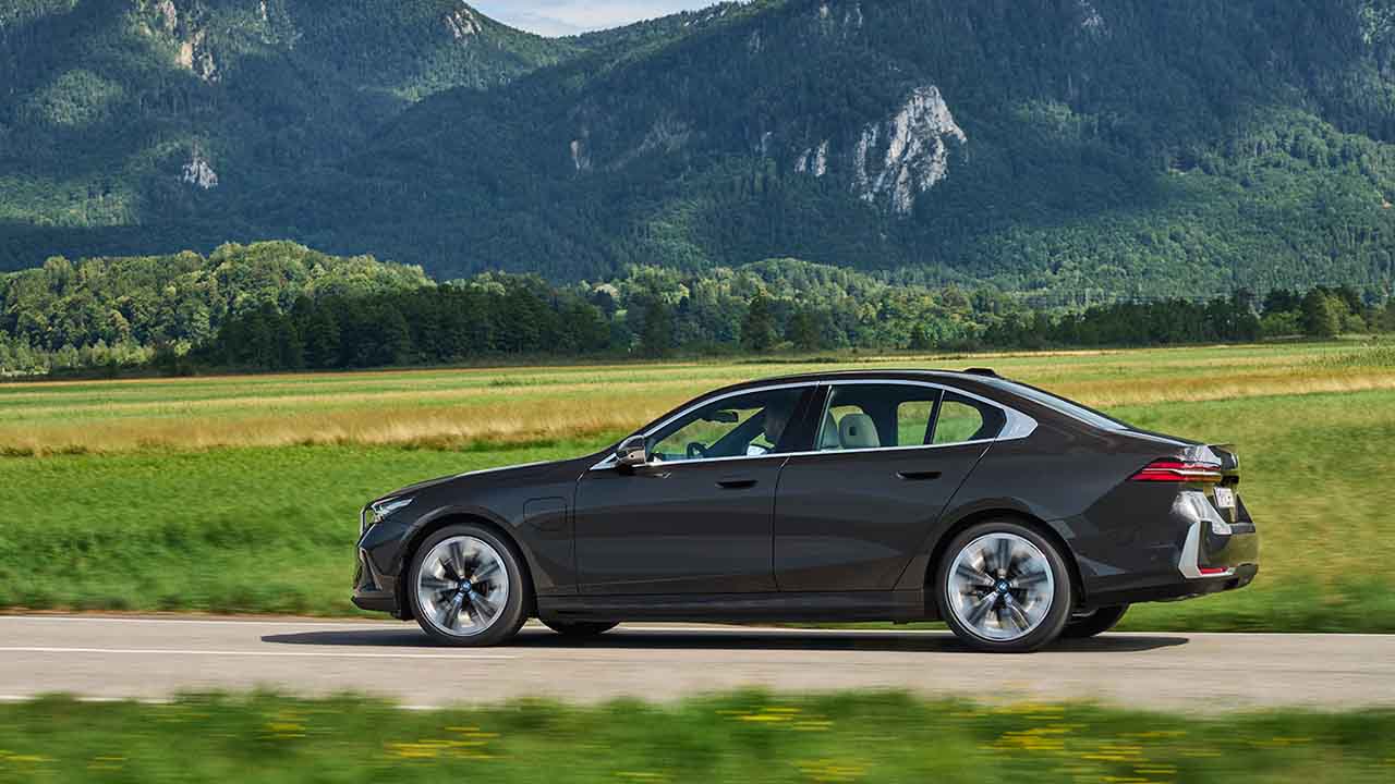Black BMW 530e Exterior Side Driving in Countryside