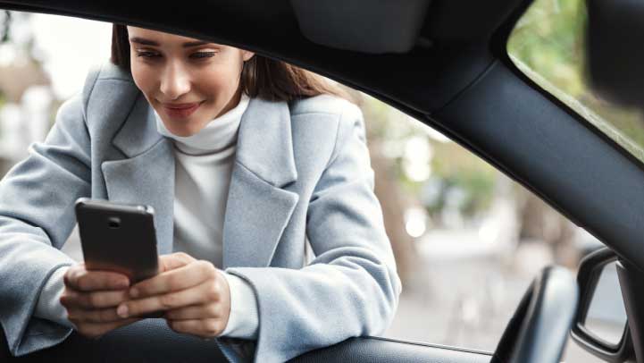 Person on Phone Leaning Through Vehicle Window