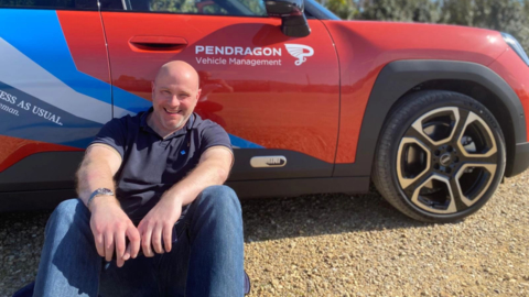 Pendragon employee sat beside vehicle